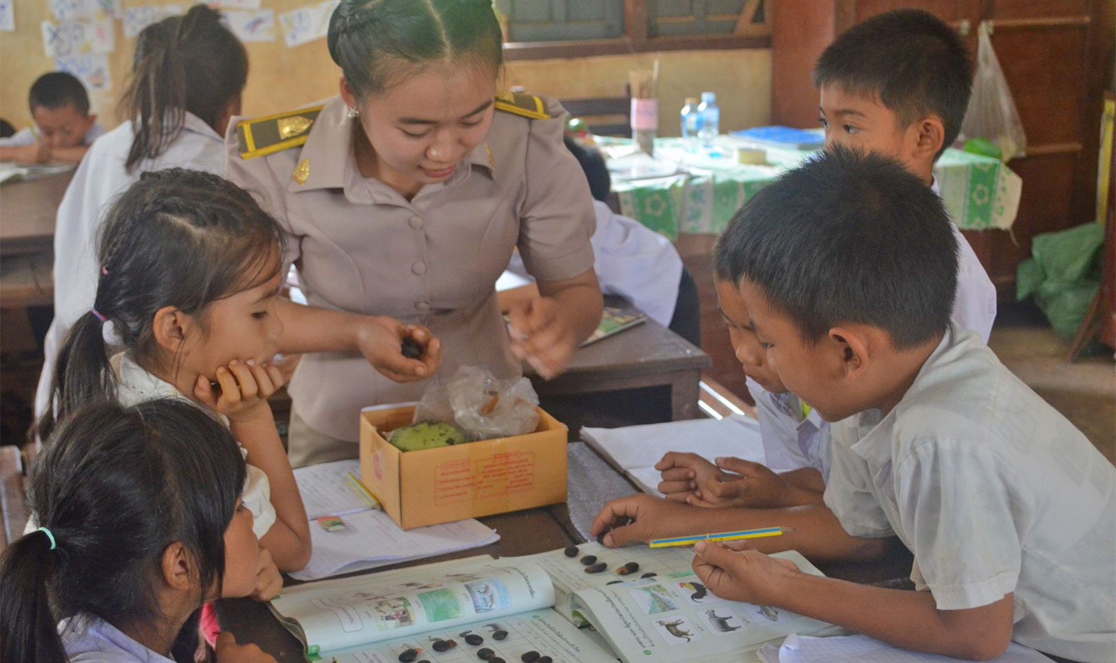 Teacher engaging students in Lao Language activity